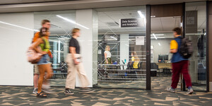 An exterior view of the Data Science and Analytics lab in Hayden Library with students coming and going.