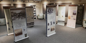 Pop-up banners of historic photographs and text displayed in a gallery