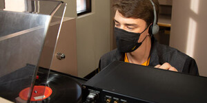 ASU student plays a record in the Music Library