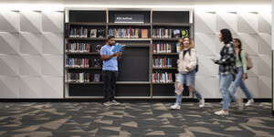 Group of students in front of bookshelf
