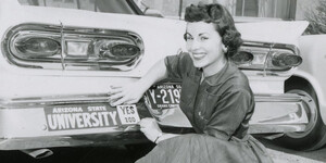 A female student shows off her Yes 200 bumper sticker in 1958.