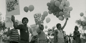 Activists hold signs at the 1983 Phoenix Pride March and Rally in Arizona.