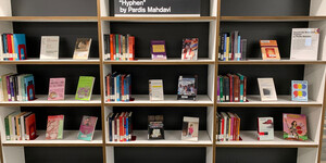 Shelves and book display featuring materials related to "Hyphen" by Pardia Mahdavi
