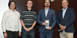  Hub staff members from left to right: Jill Sherwood (former Geospatial Data Analyst),  Eric Friesenhahn (Map and GIS Specialist), and Matthew Toro (Director of Maps, Imagery, and Geospatial Services), and ASU President Michael Crowe. Matthew Toro holds the President's Award for Innovation