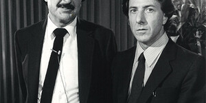 Black and white publicity photograph of two men dressed in white shirts, dark sport coats, and ties. On the right is actor Dustin Hoffman; on the left is Phoenix film critic and television host Nicholas A. Salerno.