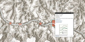 A screenshot of the Rapids Application showing three of the ten total red rectangles that represent the rapids along the Colorado River within the Grand Canyon. Black and white topography that visualizes the stunning canyon walls and landscapes are seen, with the blue of the Colorado River running left to right in the center of the image. A descriptive box is open for the rightmost of the three.