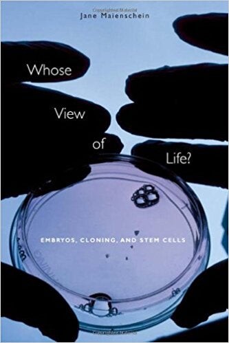 Cover of "Whose View of Life?" featuring an image of gloved hands holding a cell culture sample