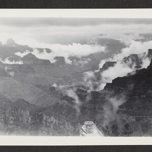 Black and white print overlooking the canyon with clouds below the canyon's highest elevations.