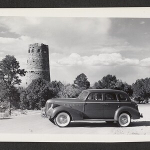 Black and white print of an automobile parked near the Watchtower.