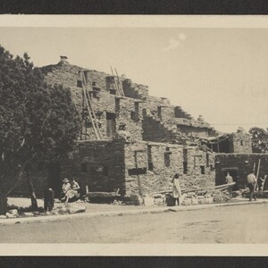 Black and white print of Hopi House with what appears to be tourists sitting outside.