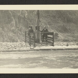 Black and white print of three women in a cable rig above the Colorado river.