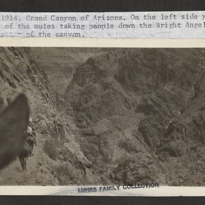 Black and white print of the Grand Canyon with a typescript annotation that reads, "July 17, 1914. Grand Canyon Arizona. On the left side you can see some of the mules taking people down the Bright Angel Trail to the bottom of the Canyon.