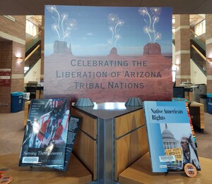 Photo featuring title of display with two books from Fletcher Library's Open Stacks on either side. Display sign designed by Ashley Davis (Navajo).