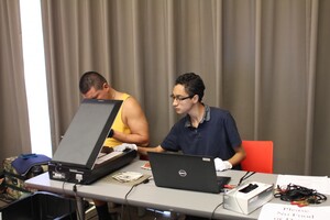 Claudio teaching a community member about digitizing photographs