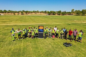 Picture of the First UAV Expo. Shows a group of people in a park with some holding drones or other UAVs.