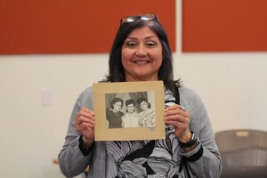Community Archivist displaying family photograph