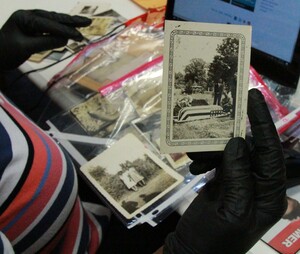 Community Archivist showing collection of family photographs.