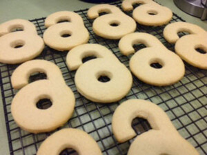 ten open access lock shaped sugar cookies on a cooling rack