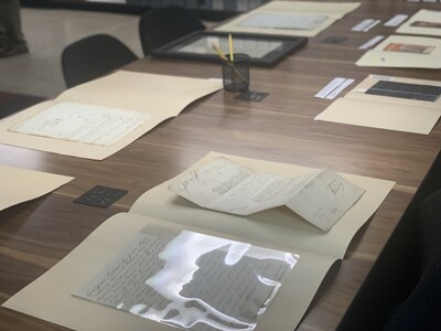 Distinctive Collections materials displayed in open folders on a table in the Wurzburger Reading Room. 