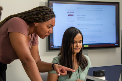 An ASU Library professional provides instruction to a student working on a laptop.