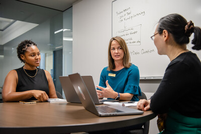 ASU Library professional consults with two researchers in a conference room.