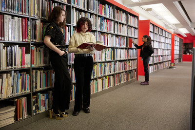 Students browsing books in the ASU FIDM Library.