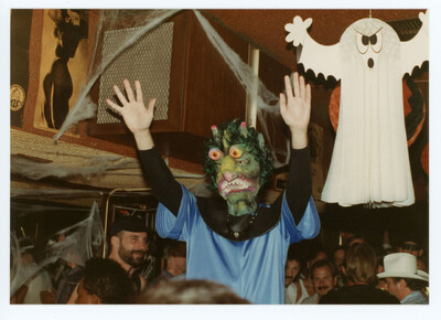 This person really gets the party going dancing above the crowd with their monster mask (1987)