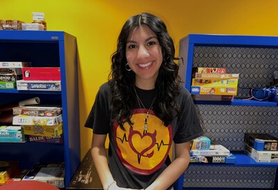 Portrait of Natalie Robles in front of the game section at the Downtown Phoenix campus Library