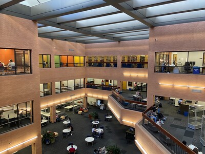 An interior view of Noble Library with people sitting, reading and studying on the first, second, third floor