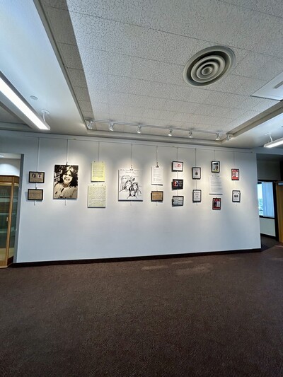Photo of the Jean Chaudhuri Exhibit on the third floor of Fletcher Library. The Labriola Center's door is on the right side.