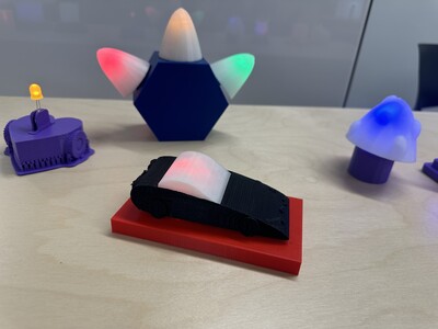 Several 3D printed models in different colors and shapes