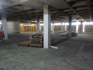 Photo showing the 4th floor of Hayden Library, after demolition, with most of the walls removed